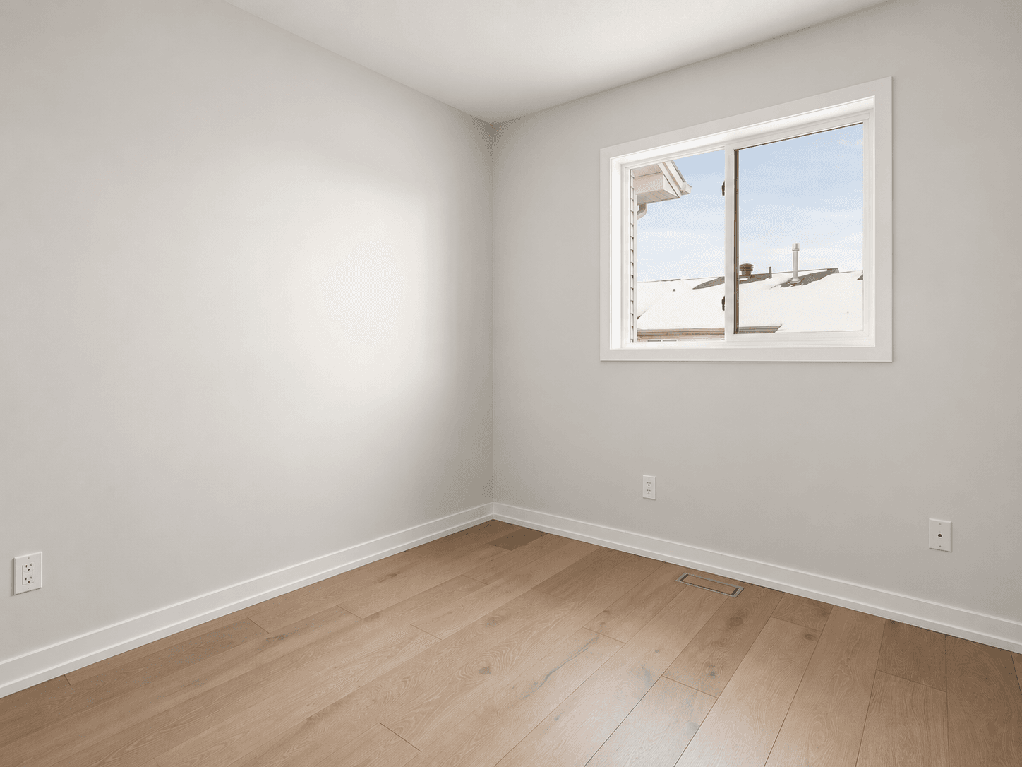 A light interior with a window and smooth plastered walls